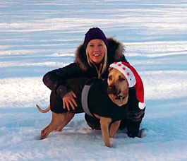 Photo of Nicole in the snow with a dog